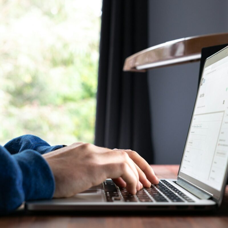 person using macbook pro on table
